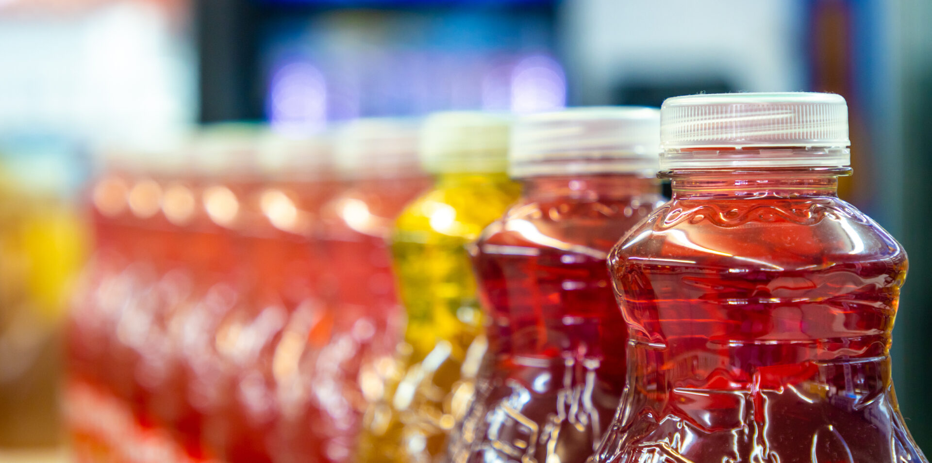 Row of juice bottles on store shelf