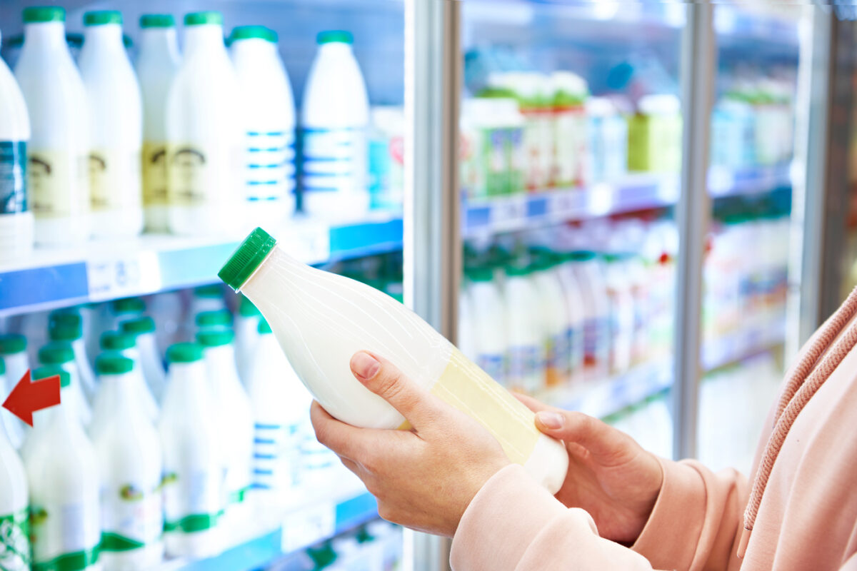 Woman shopping milk in grocery store