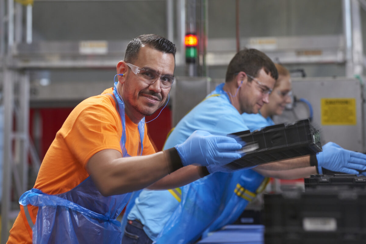 Tosca service center workers manage the pooling process of washing and sanitizing plastic crates for reuse, offering a sustainable alternative to single-use packaging.