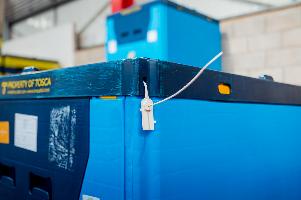 Close-up of a blue Tosca reusable bulk container with a tamper-evident security seal, highlighting secure and reliable packaging for safe chemicals product transport.