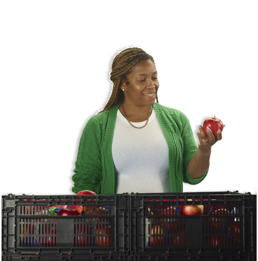 Woman holding an apple from a reusable crate