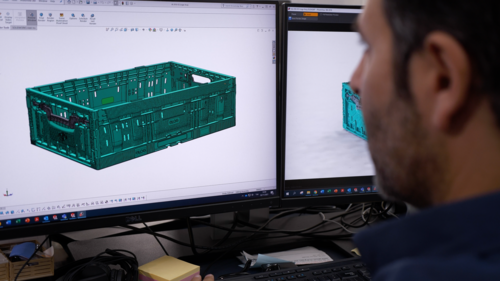 A Tosca engineer views a product rendering of a reusable plastic crate on a computer screen. Product ideation is one of several phases in the customization process designed to meet clients’ unique needs.