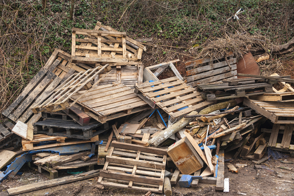 Wooden pallets (seen in this image) end up in piles, unlike reusable plastic pallets, which last for years to come