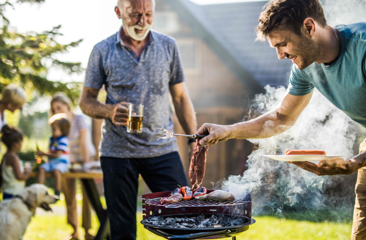 A man is placing meat on a smoking hot grill during a summer family cookout. Tosca works hard to meet the demands of grilling season for the meat industry.