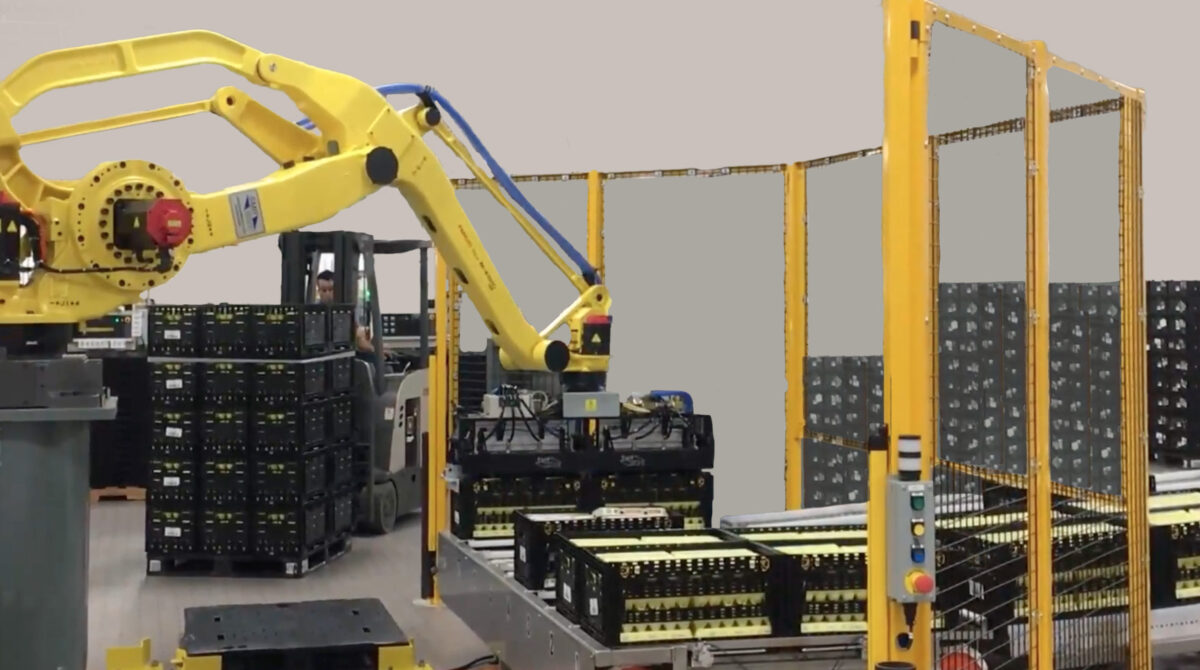 A robotic arm stacks crates inside an automated tosca facility
