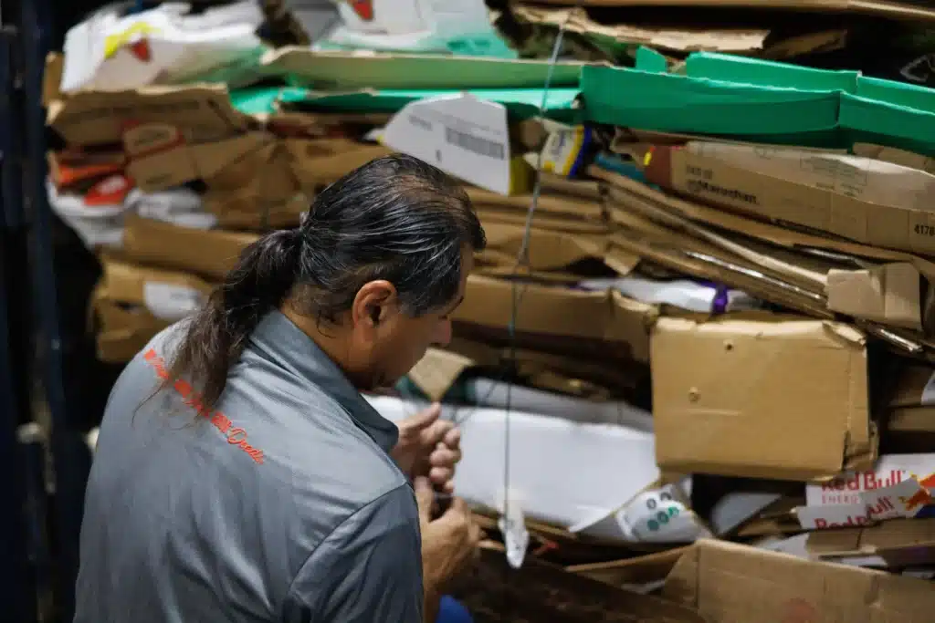 Worker working on Brookshire brothers bailer.